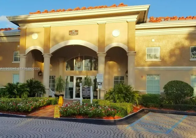 a living room with fireplace furniture and a large window