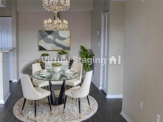 a view of a dining room with furniture and chandelier