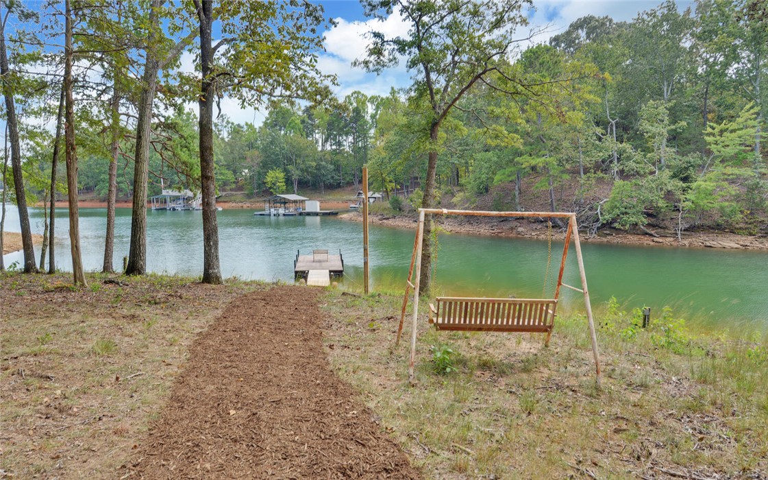 398 Hidden Point Road Hartwell, GA 30643 - Photo 33 of 46 This tranquil lakeside property boasts a private dock and mature trees, perfect for serene waterfront living.
