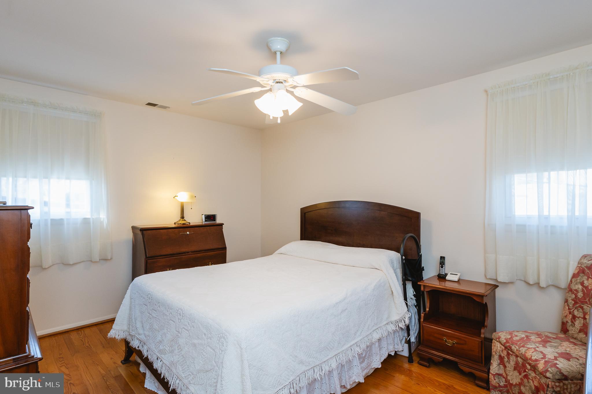 8337 Analee Avenue Rosedale, MD 21237 - Photo 18 of 48 a bedroom with a bed and a chandelier