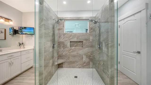 a bathroom with a sink a toilet and shower