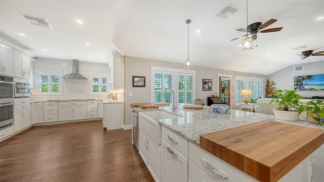 a kitchen with granite countertop kitchen island and stainless steel appliances