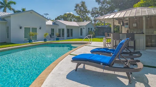 a view of swimming pool with lounge chair