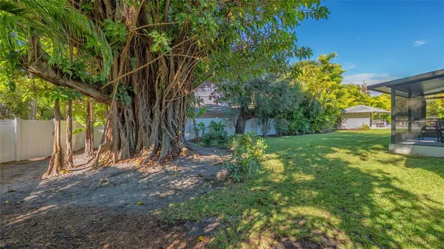 an aerial view of a house with a garden and trees