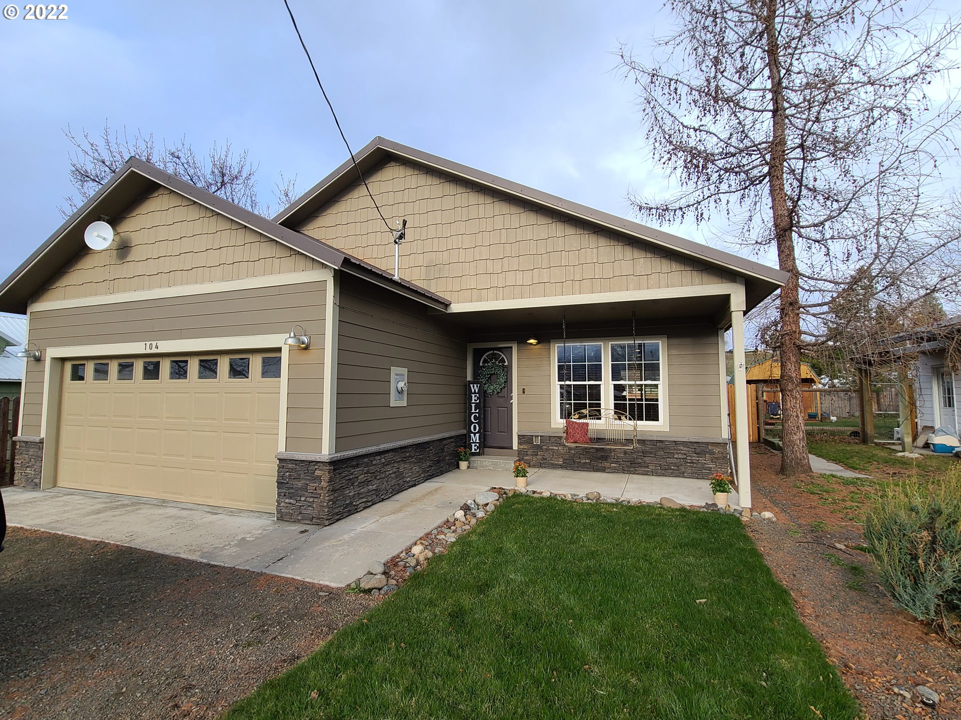 104 North College Street Joseph, OR 97846 - Photo 1 of 17 a view of a house with a yard plants and large tree
