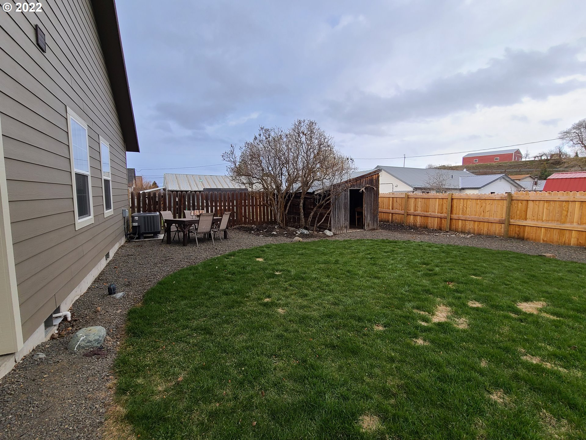 104 North College Street Joseph, OR 97846 - Photo 14 of 17 a view of a house with a big yard and potted plants