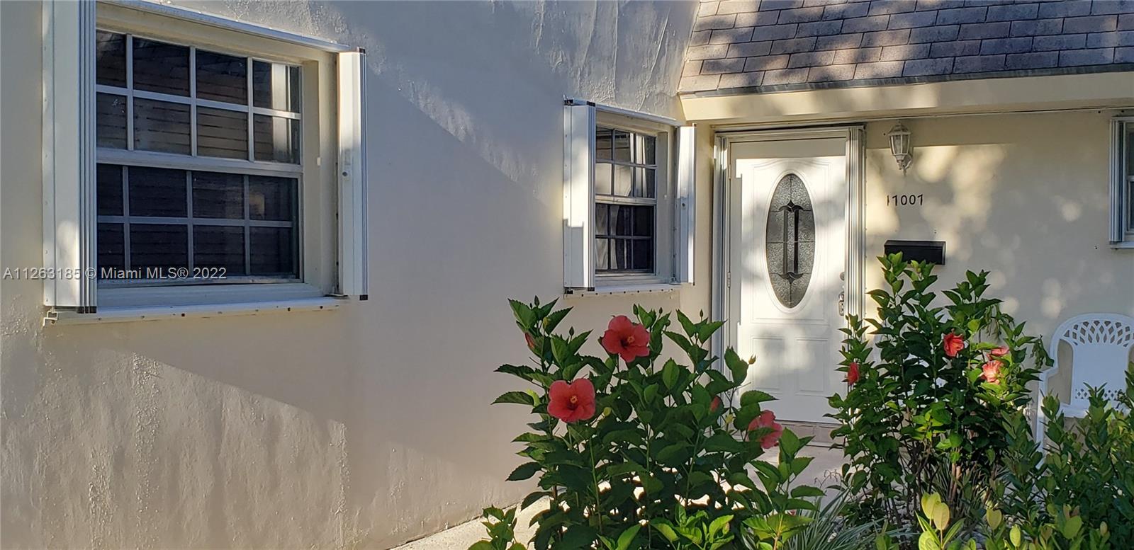 West Perrine Miami, FL 33157 - Photo 2 of 34 a front view of a house with a flower garden