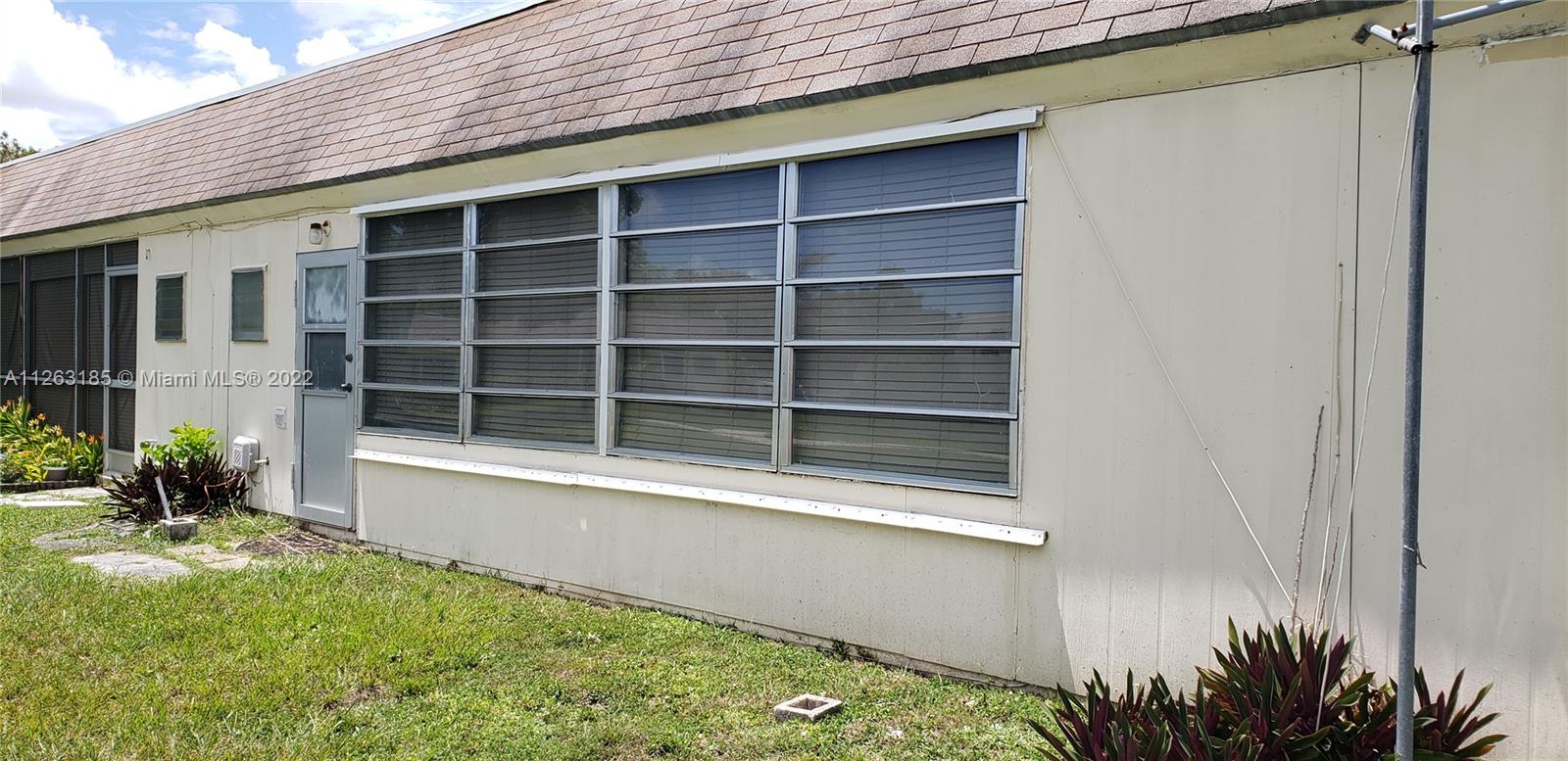 West Perrine Miami, FL 33157 - Photo 25 of 34 a view of a house with a large window and chair