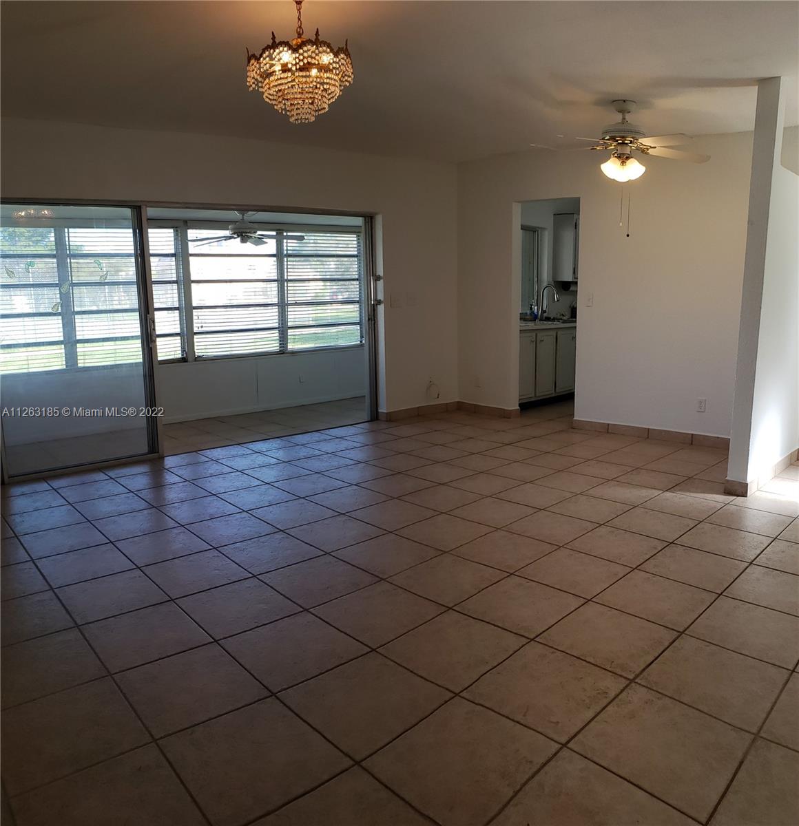 West Perrine Miami, FL 33157 - Photo 4 of 34 an empty room with windows and chandelier