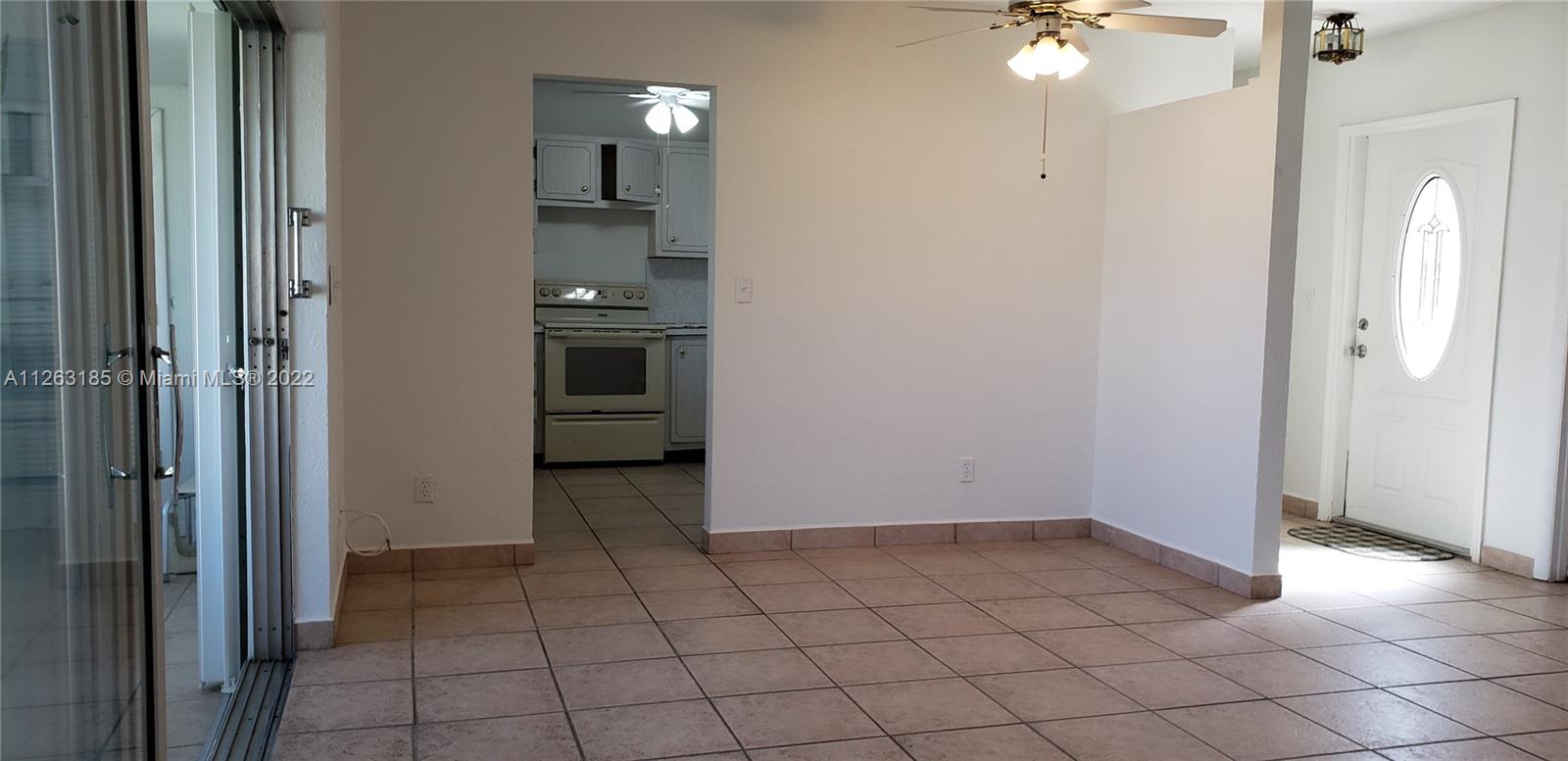 West Perrine Miami, FL 33157 - Photo 6 of 34 an empty room with kitchen and mirrors