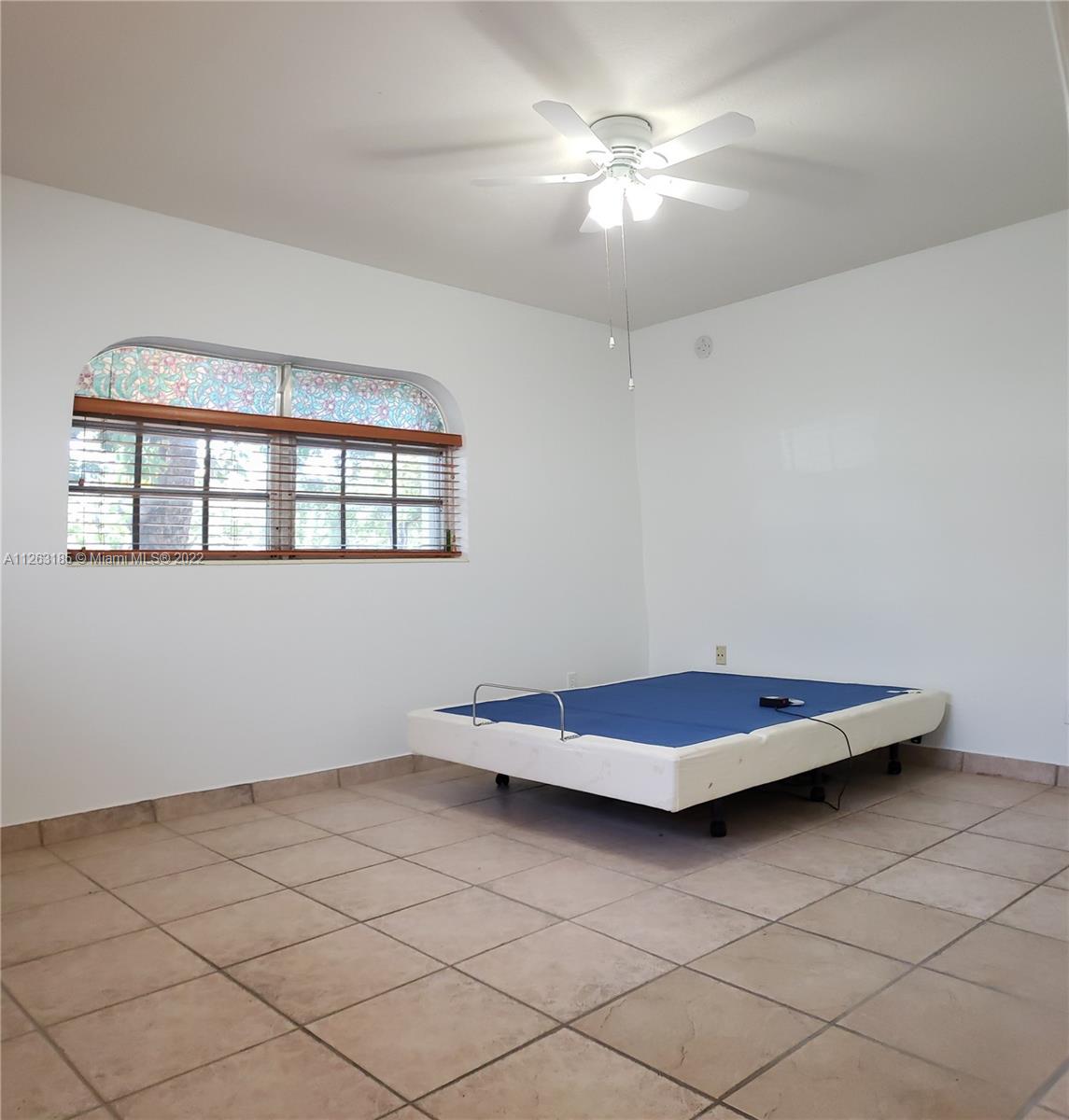 West Perrine Miami, FL 33157 - Photo 8 of 34 a living room with a couch and chandelier