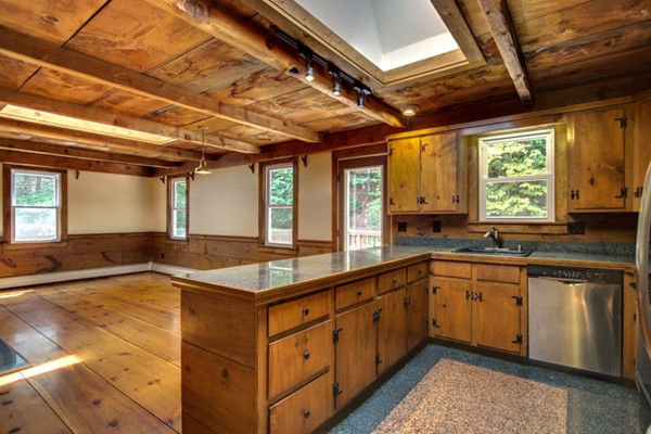 211 Littleton County Road Harvard, MA 01451 - Photo 17 of 30 a large kitchen with kitchen island a large window a sink and stainless steel appliances