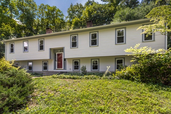 211 Littleton County Road Harvard, MA 01451 - Photo 2 of 30 a front view of house with yard and trees in the background