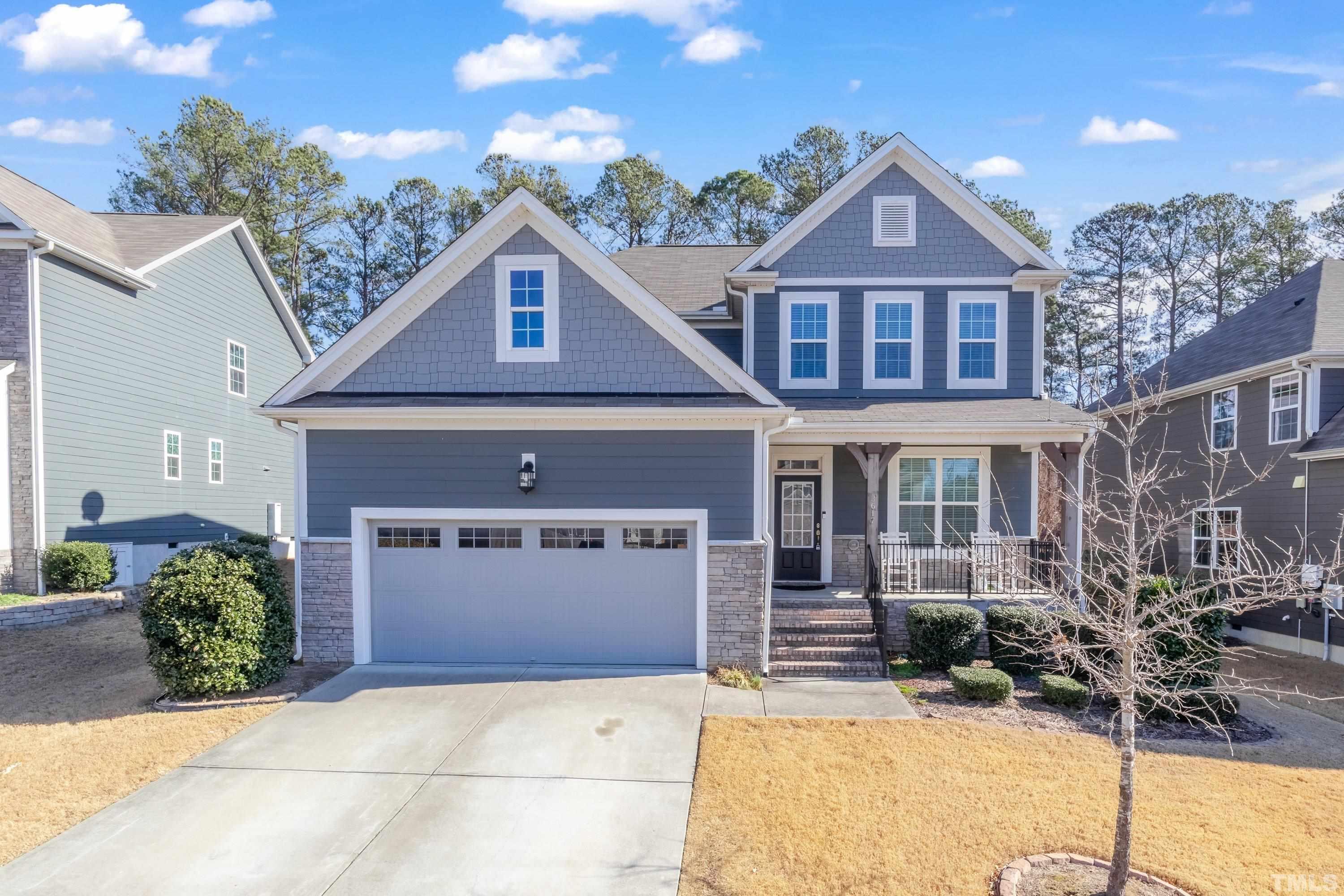 3617 Lily Orchard Way Apex, NC 27539 - Photo 1 of 47 a front view of a house with a yard and garage