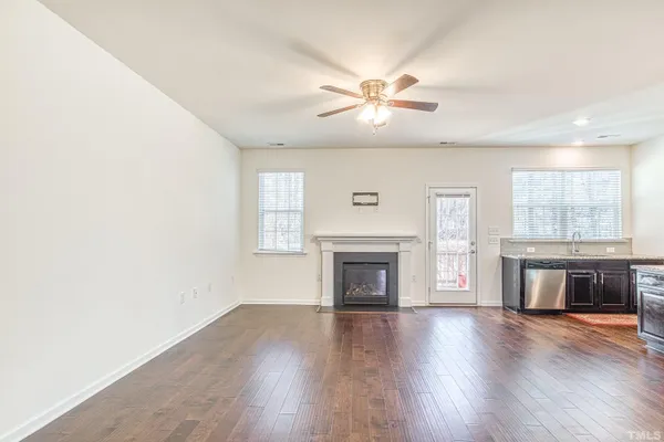 a view of main area fire place window and wooden floor