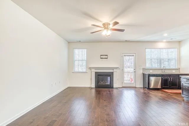 a view of main area fire place window and wooden floor