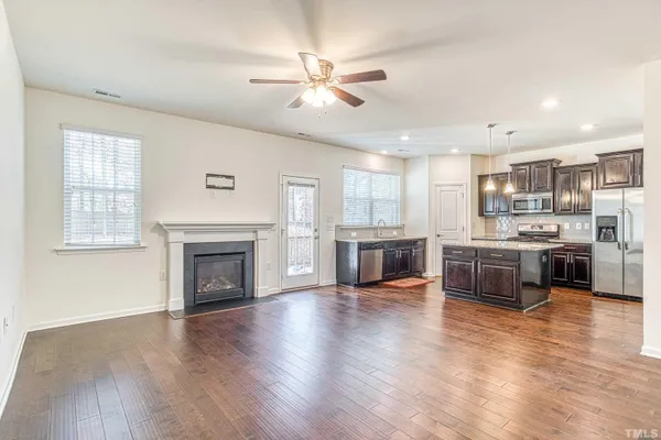 a large kitchen with a stove top oven and refrigerator