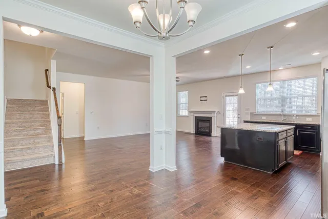 a open kitchen with a refrigerator and a stove top oven