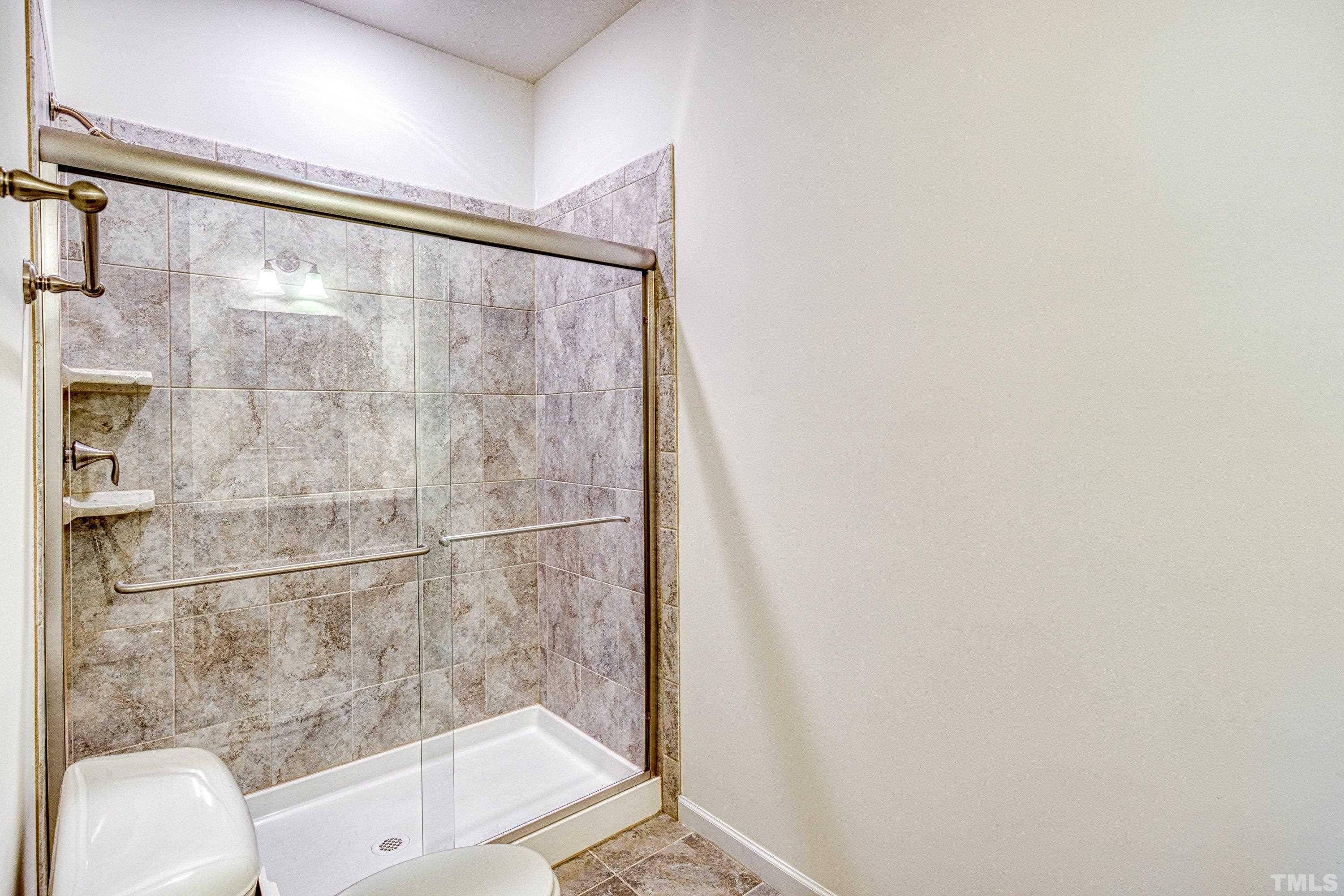 3617 Lily Orchard Way Cary, NC 27518 - Photo 28 of 47 a bathroom with a bathtub