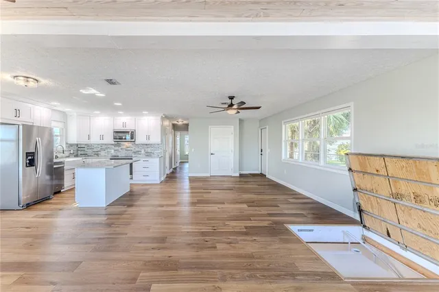an aerial view of ocean and residential houses with outdoor space
