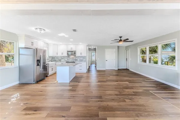 a view of a room with wooden floor and bathroom
