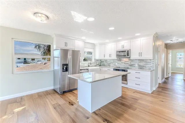 a view of a hallway with wooden floor and closet area