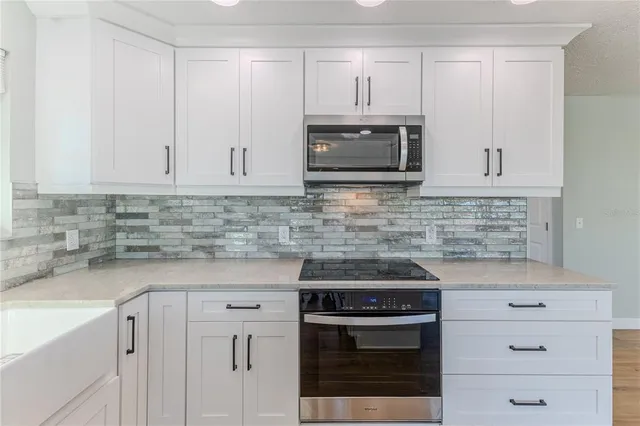 a bathroom with a granite countertop shower a toilet and a sink