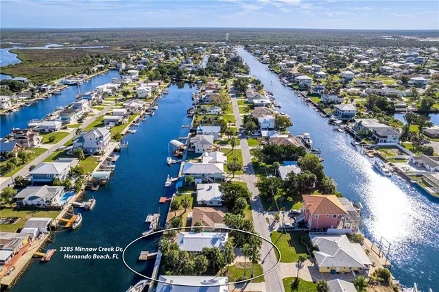 an aerial view of a house with a yard and garden