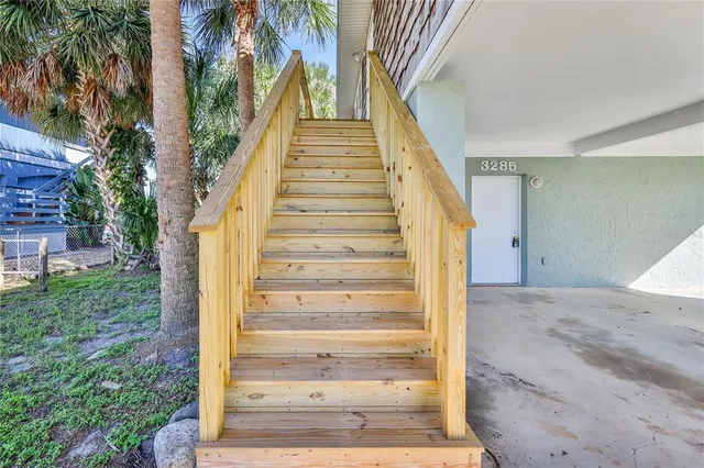 a view of balcony with wooden floor and fence