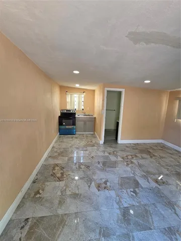 a view of a livingroom with an empty space and a window