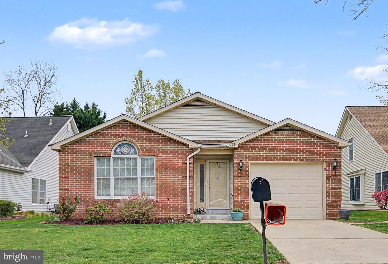 a view of a yard in front of a house with plants
