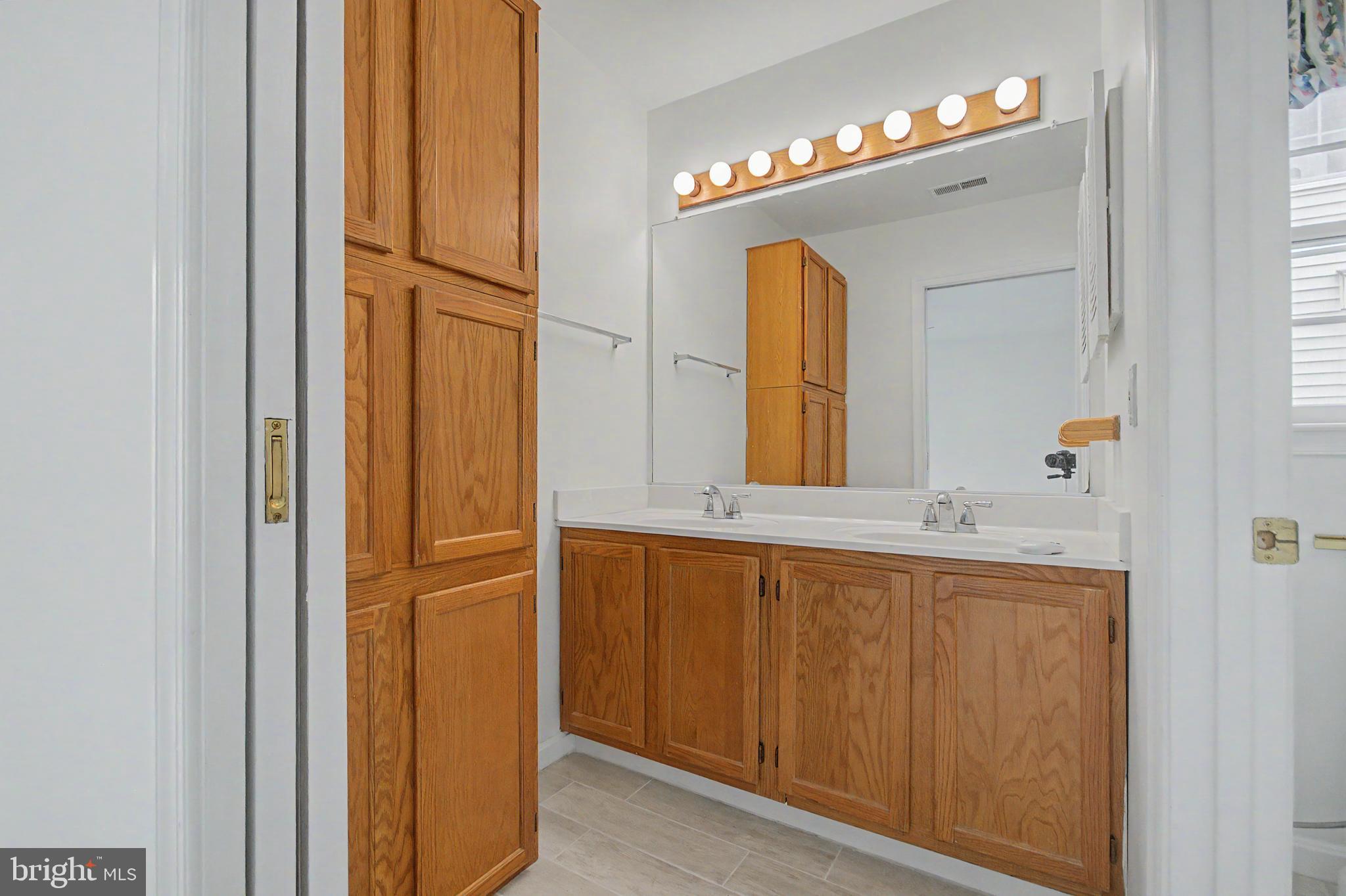 795 Eastern Point Road Annapolis, MD 21401 - Photo 11 of 38 a bathroom with a mirror and a sink