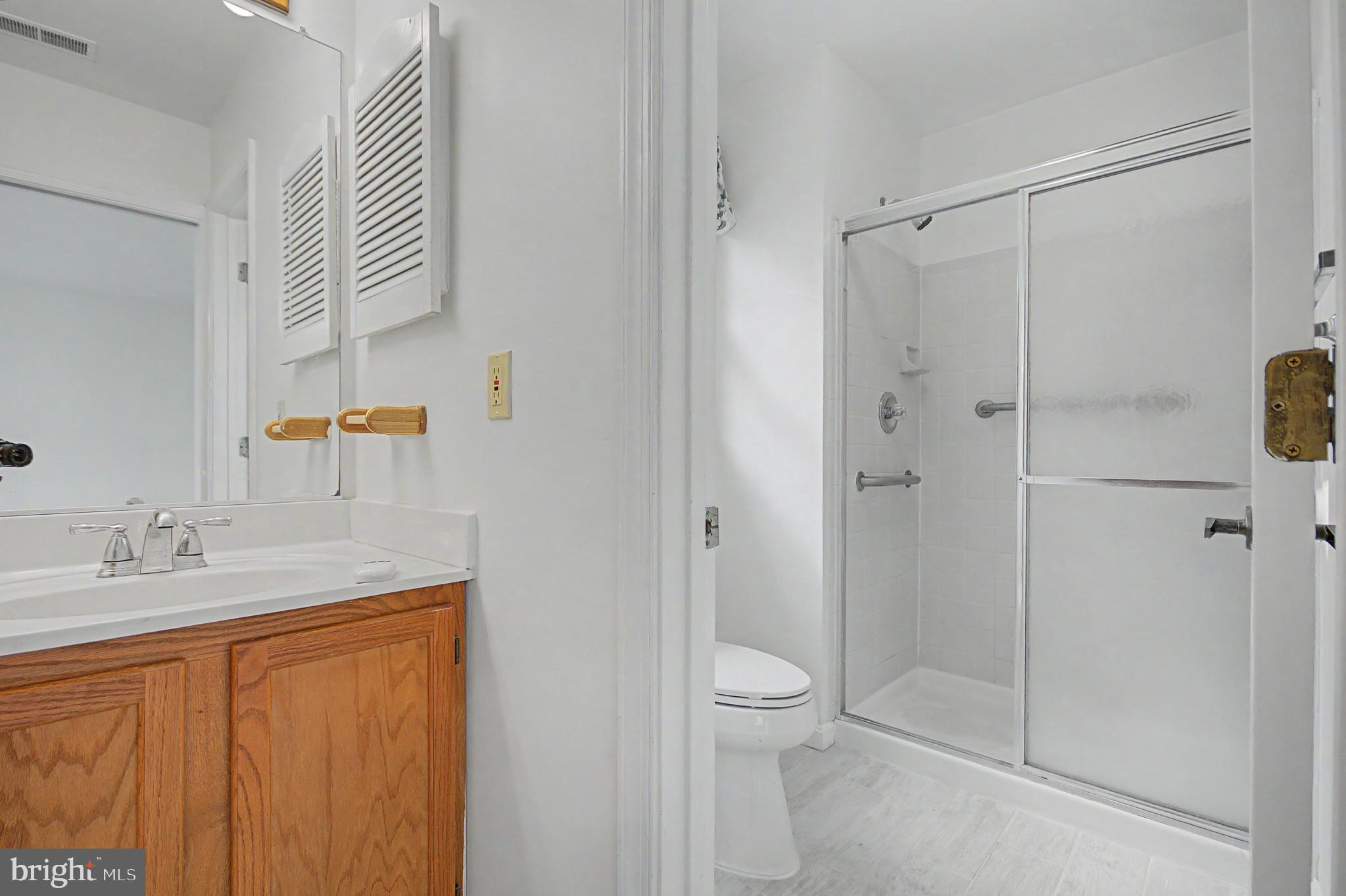 795 Eastern Point Road Annapolis, MD 21401 - Photo 12 of 38 a bathroom with a granite countertop sink toilet and shower