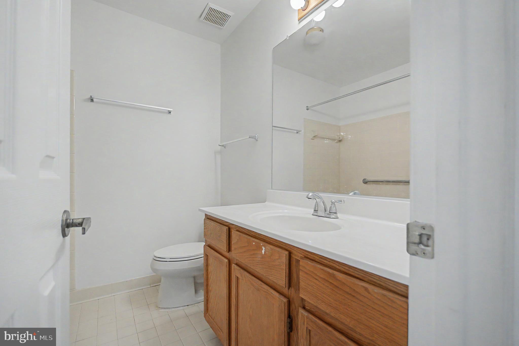 795 Eastern Point Road Annapolis, MD 21401 - Photo 14 of 38 a bathroom with a sink toilet and vanity