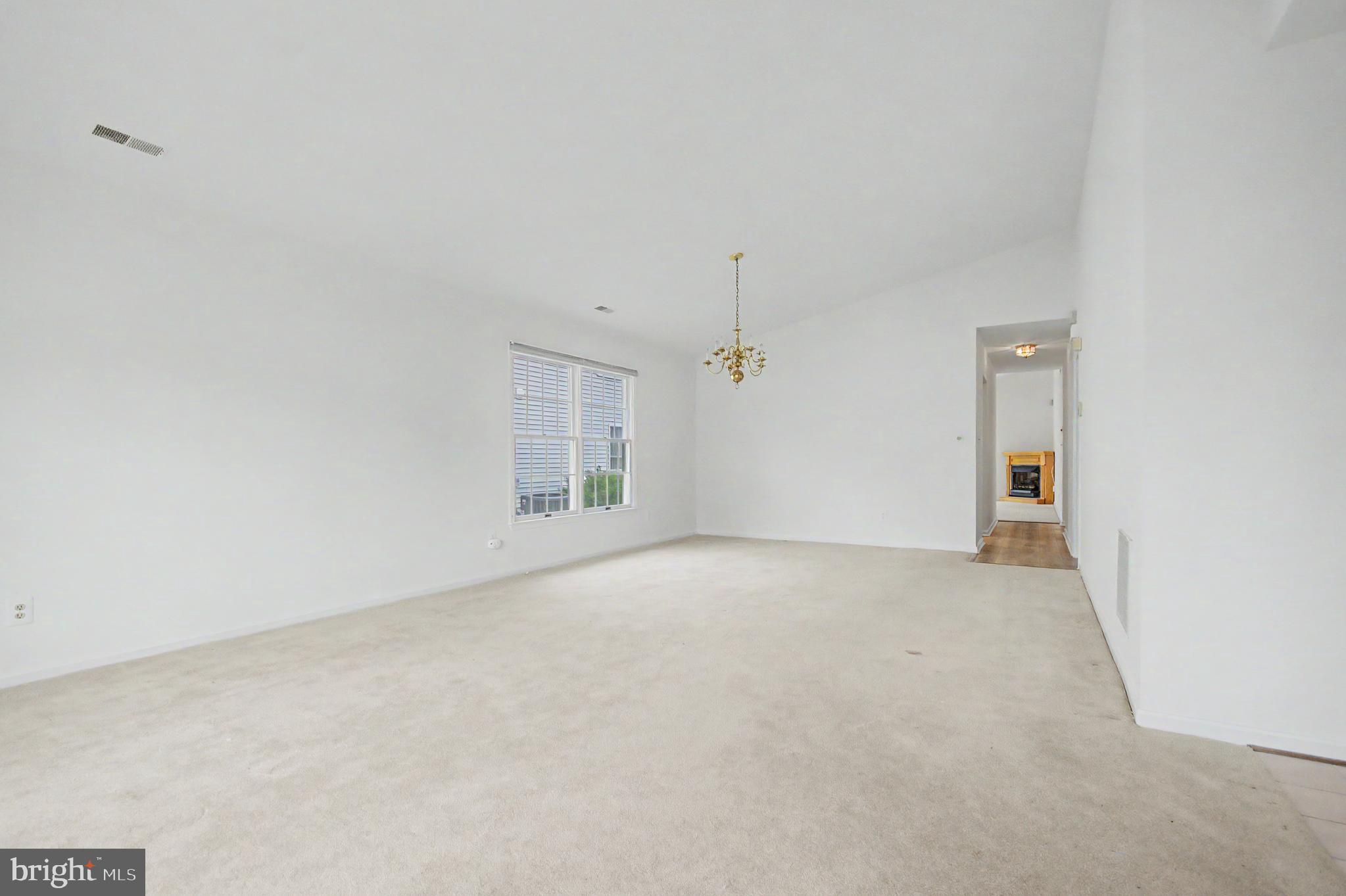 795 Eastern Point Road Annapolis, MD 21401 - Photo 4 of 38 an empty room with a empty space and windows