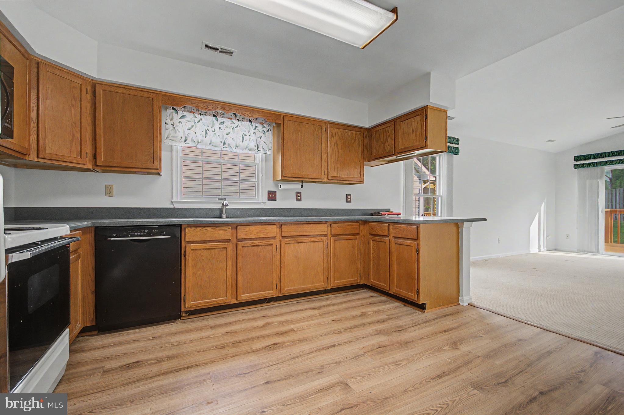 795 Eastern Point Road Annapolis, MD 21401 - Photo 5 of 38 a kitchen with stainless steel appliances granite countertop a sink cabinets and wooden floor