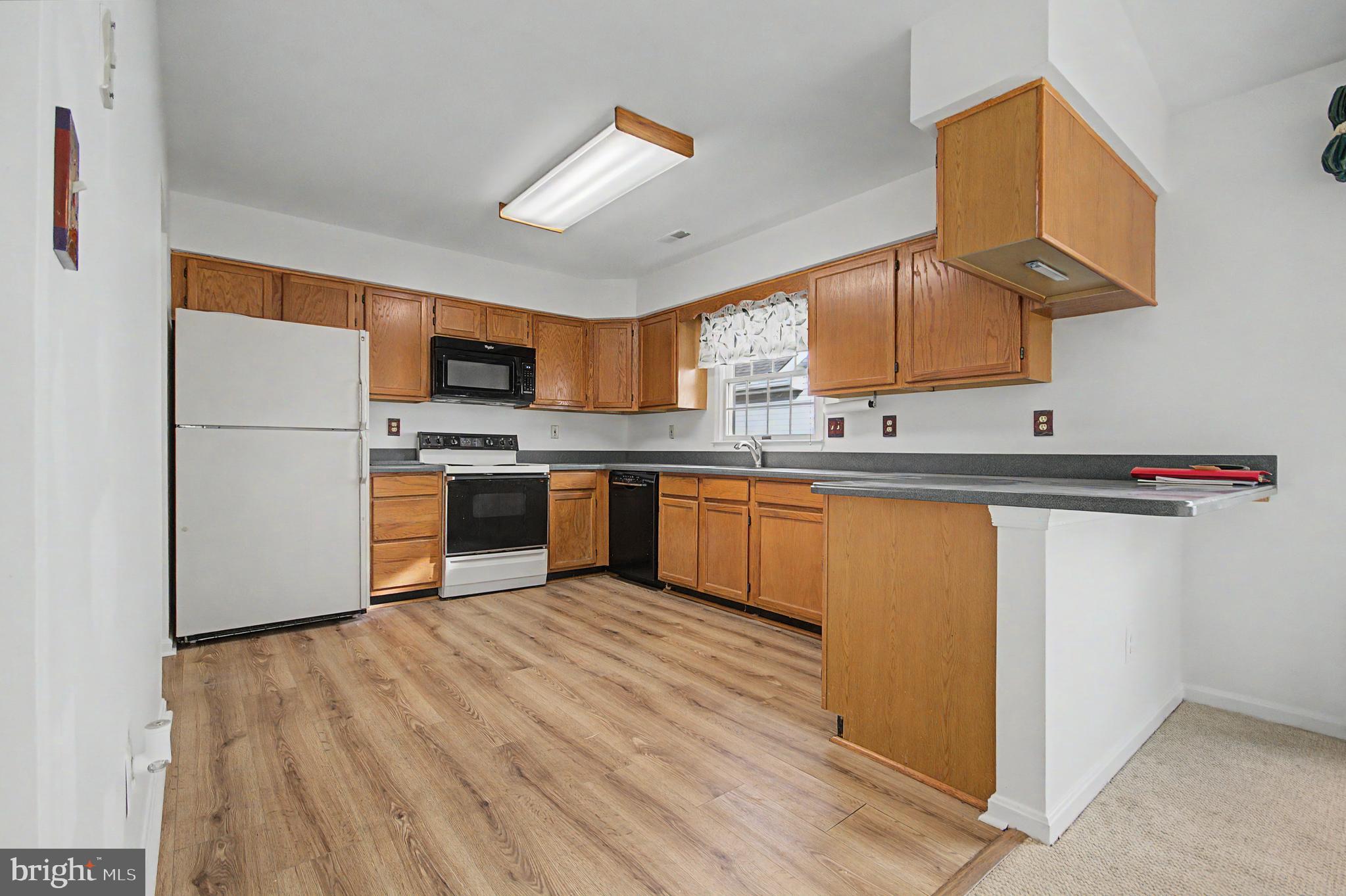 795 Eastern Point Road Annapolis, MD 21401 - Photo 6 of 38 a kitchen with stainless steel appliances granite countertop a sink stove and refrigerator