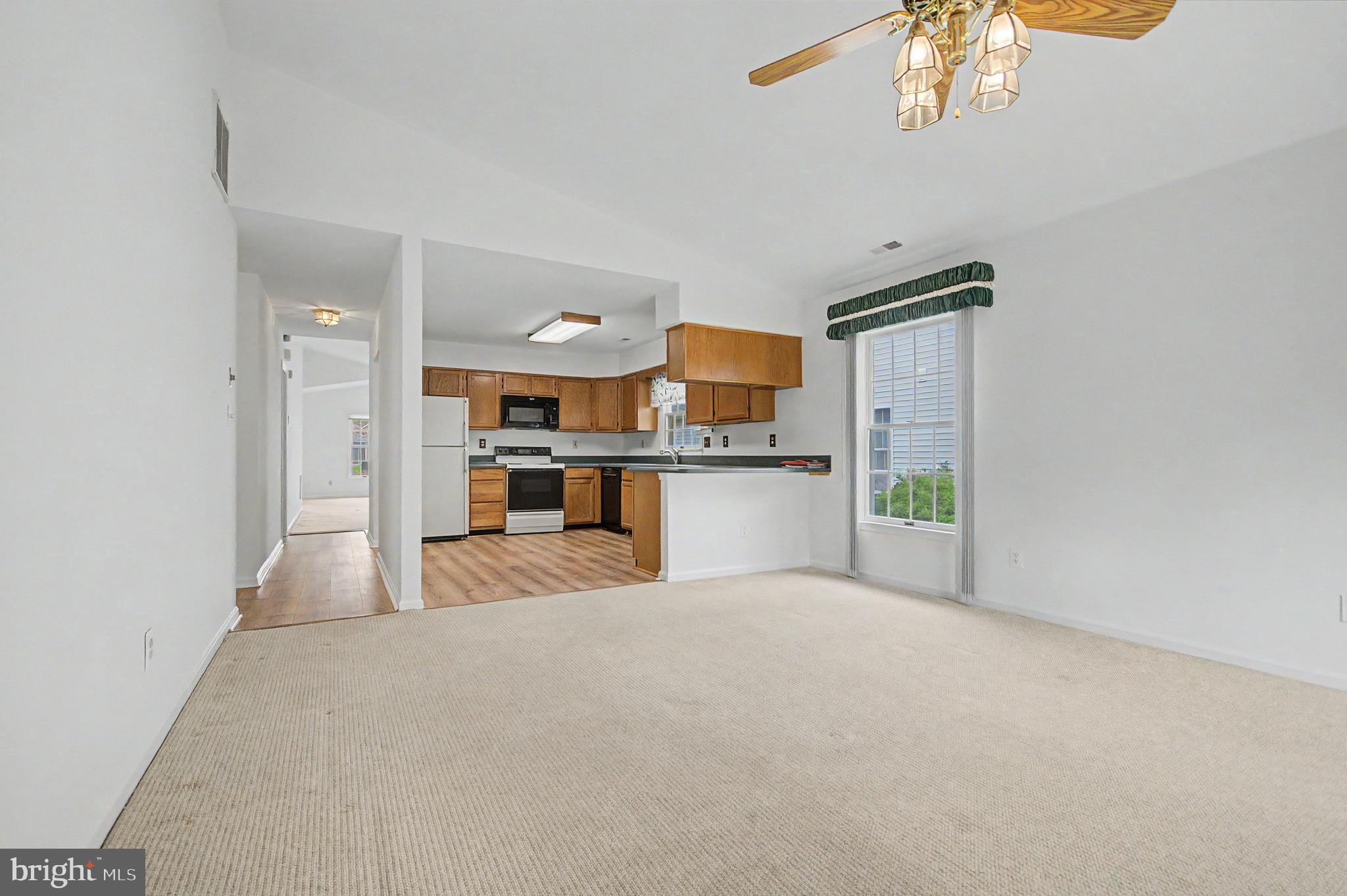 795 Eastern Point Road Annapolis, MD 21401 - Photo 8 of 38 a view of a kitchen with a sink and a refrigerator