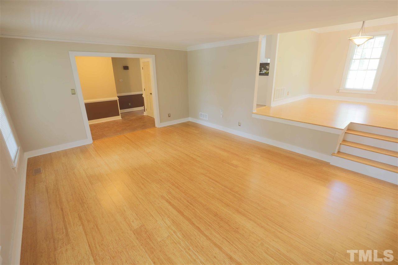 2017 Mallard Lane Raleigh, NC 27609 - Photo 11 of 25 an empty room with a fireplace and painted walls