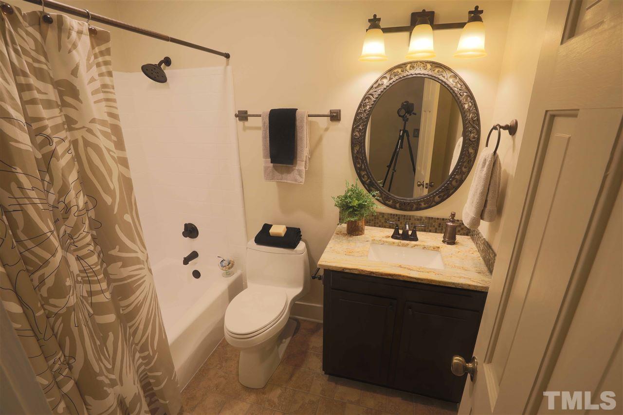 2017 Mallard Lane Raleigh, NC 27609 - Photo 24 of 25 a bathroom with a sink and mirror with toilet