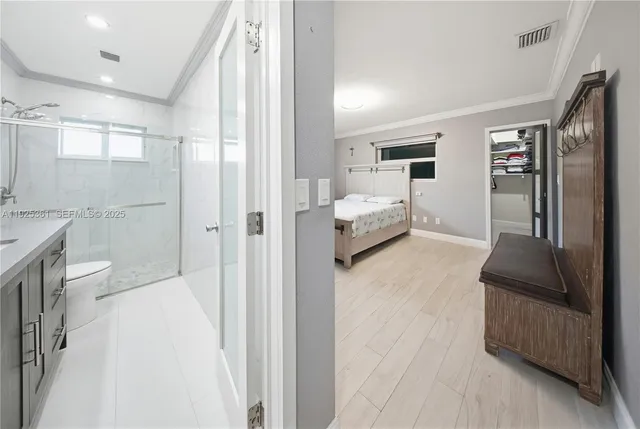 a view of walk in closet with clothes and shoes