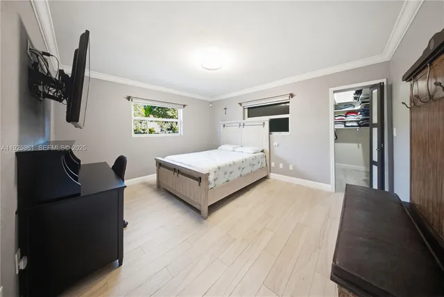 a bathroom with a granite countertop sink a toilet a mirror and shower