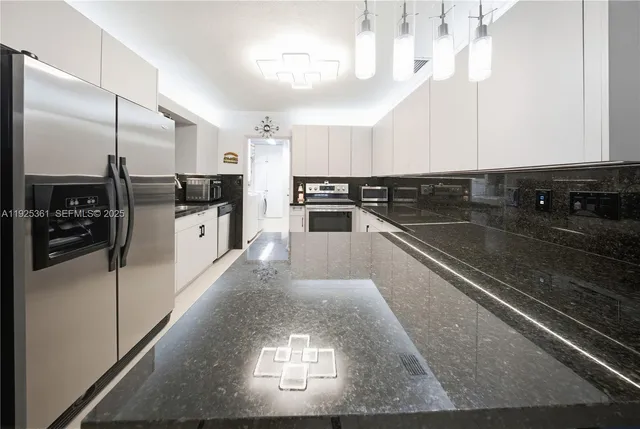 a kitchen with a refrigerator and a sink