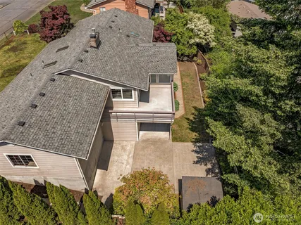 an aerial view of a house with a yard