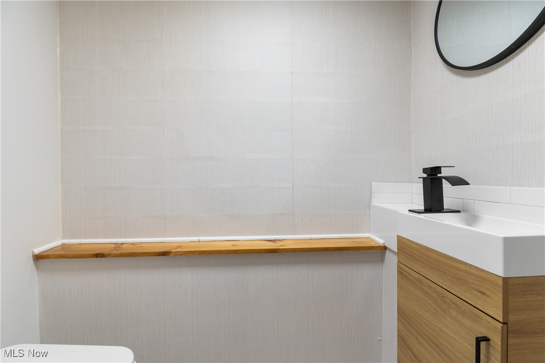 4560 7th Street Northwest Canton, OH 44708 - Photo 20 of 28 Half bath with vanity and toilet