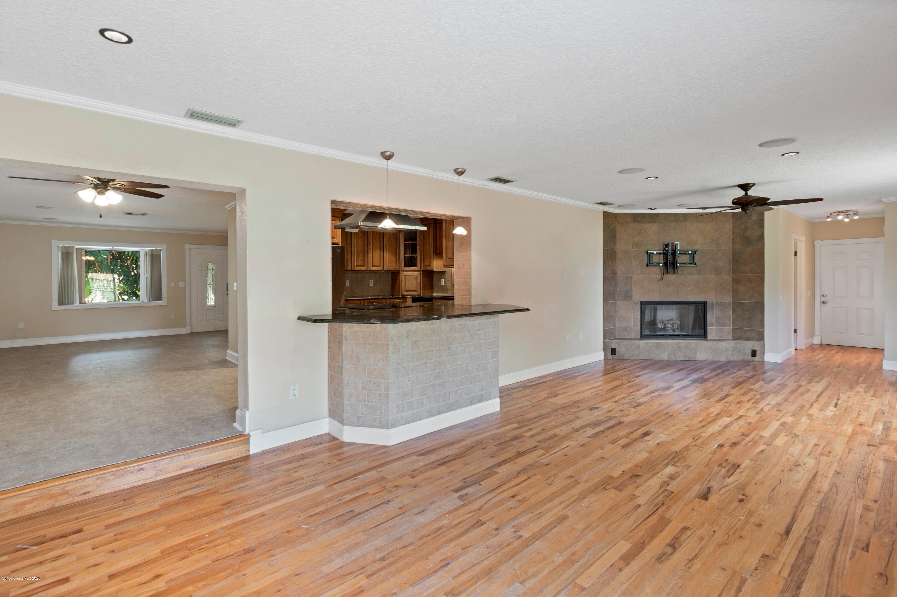 839 Knecht Road Northeast Palm Bay, FL 32905 - Photo 11 of 37 a view of a room with wooden floor and a fireplace