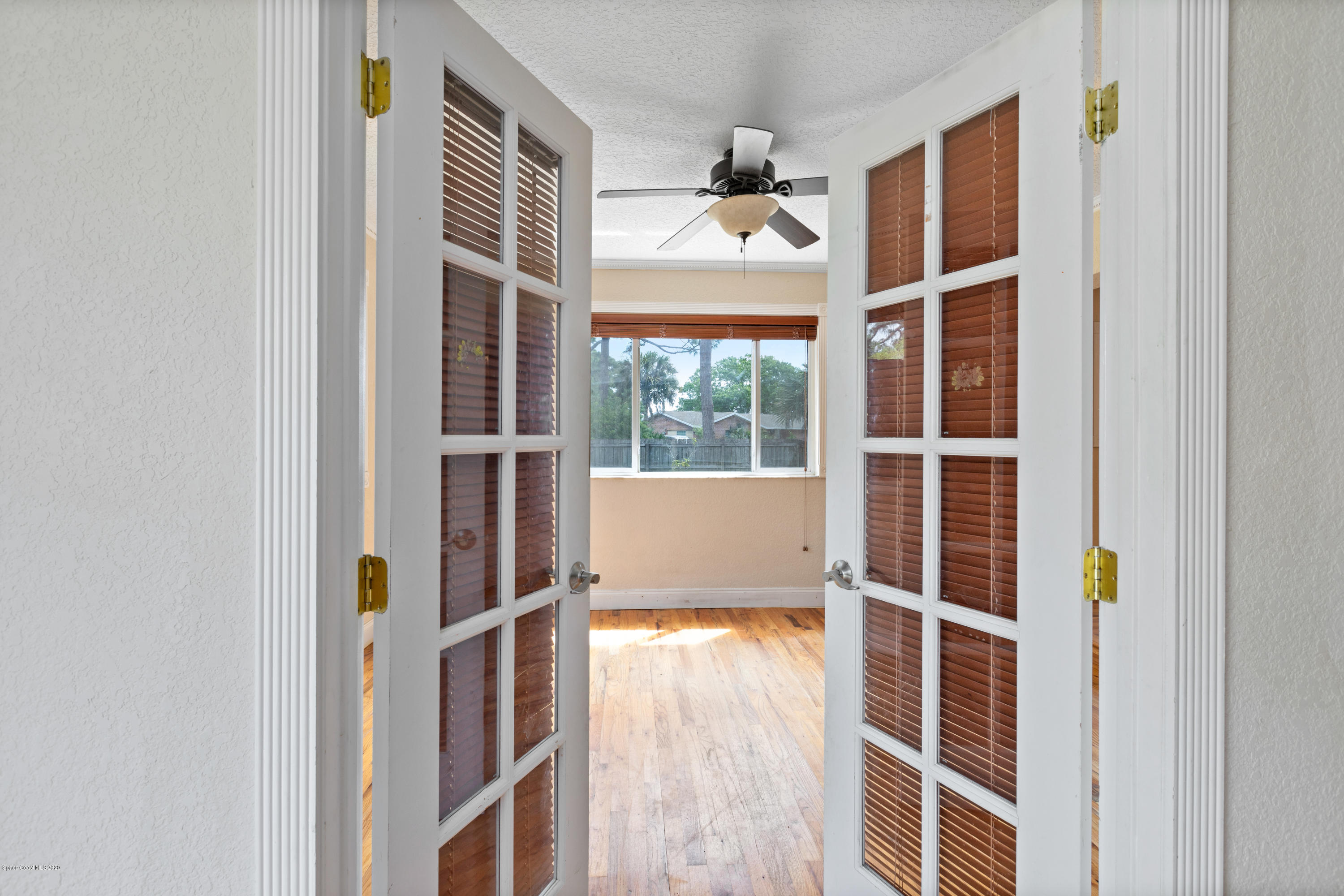 839 Knecht Road Northeast Palm Bay, FL 32905 - Photo 14 of 37 a view of an empty room with wooden floor and windows