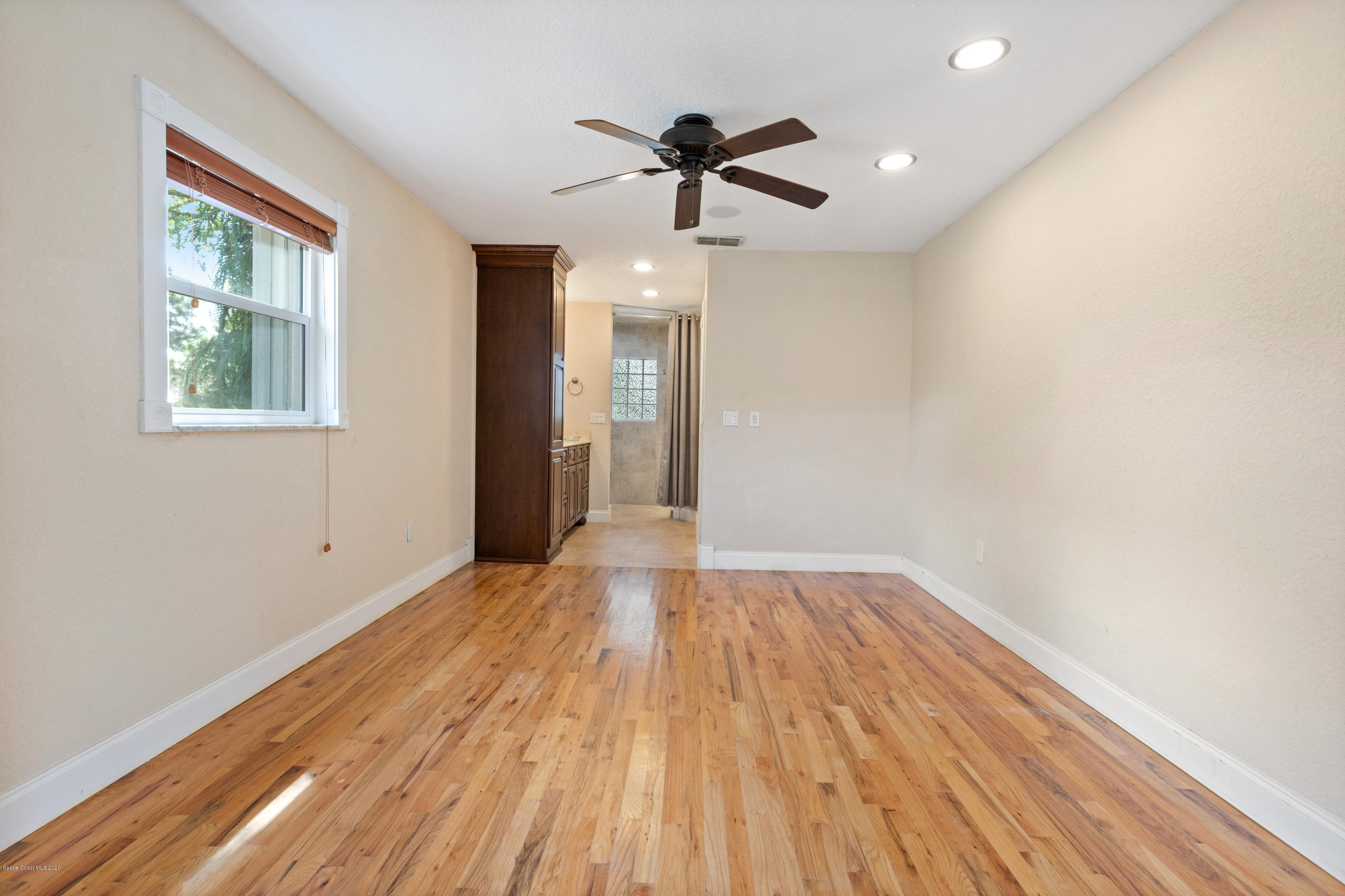 839 Knecht Road Northeast Palm Bay, FL 32905 - Photo 17 of 37 a view of empty room with wooden floor and fan