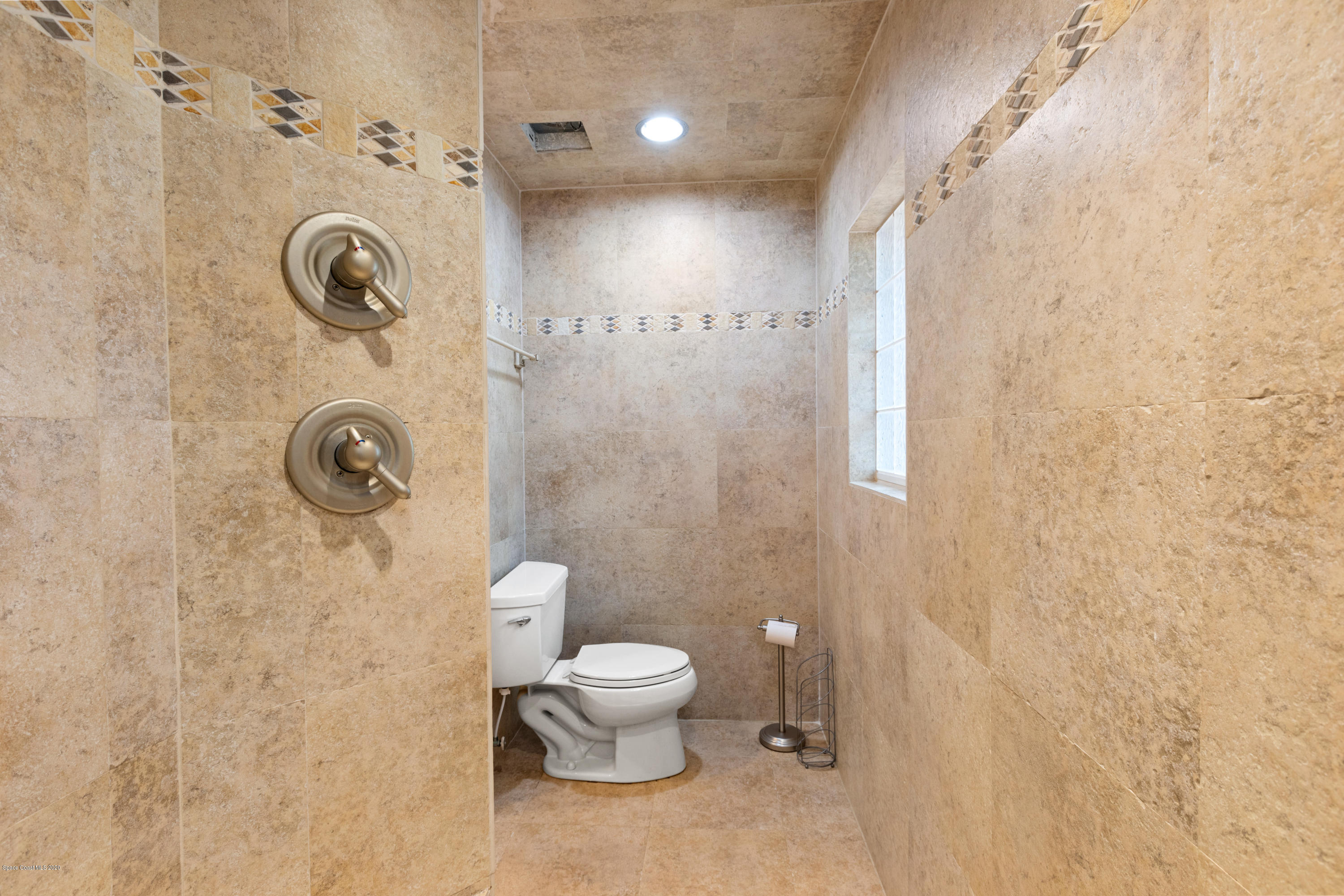 839 Knecht Road Northeast Palm Bay, FL 32905 - Photo 20 of 37 a bathroom with a toilet and a shower