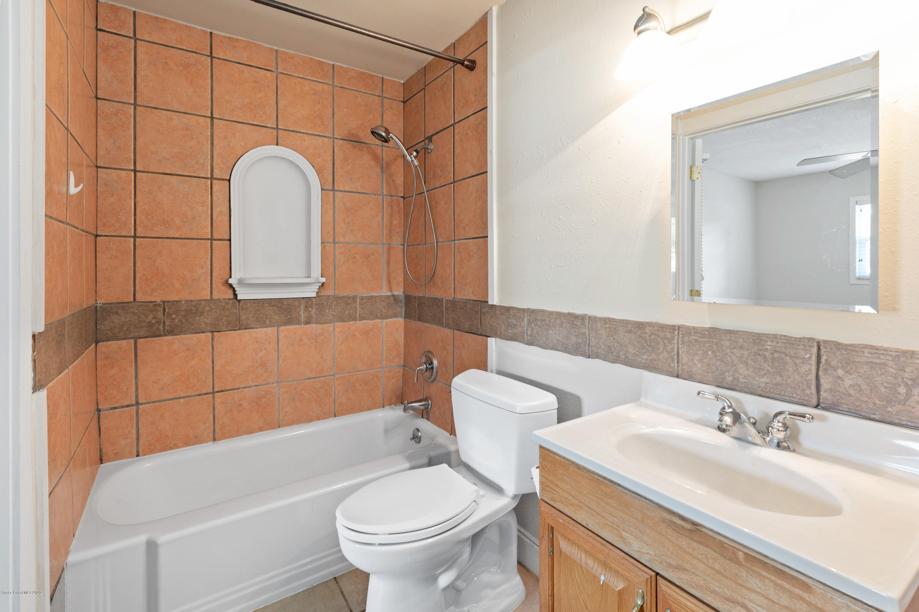 839 Knecht Road Northeast Palm Bay, FL 32905 - Photo 27 of 37 a bathroom with a sink a toilet and mirror